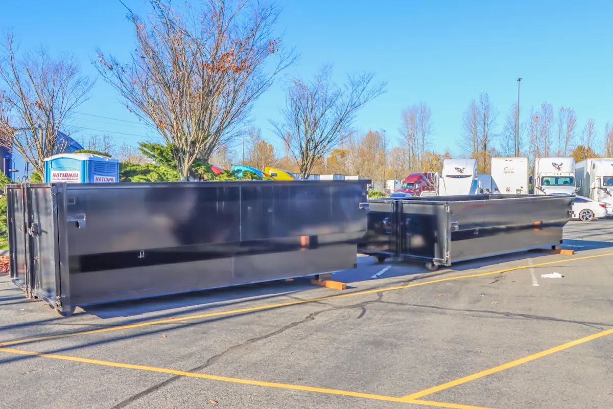 Professional dumpster rental service with roll-off container on residential driveway in Boonton